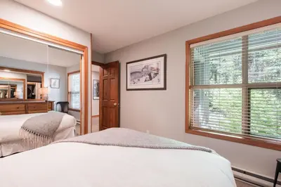 a bedroom with two beds and a window at Arrowhead Point by Outpost Whistler in Whistler