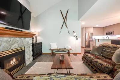 a living room with a couch and a fireplace at Arrowhead Point by Outpost Whistler in Whistler