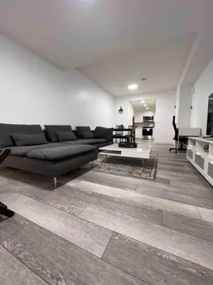 a living room with a couch and a table at 2BR Suite, Private Entry, Full Kitchen, Washer & Dryer, Free Parking, Smart TV with Netflix, High-Speed Wi-Fi, Self Check-In, Near Banff National Park in Calgary