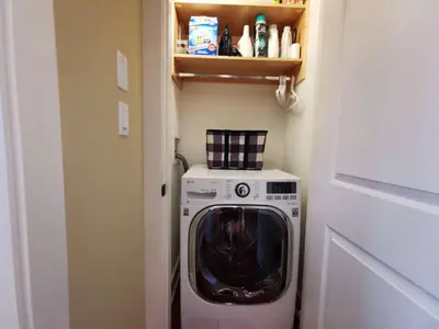 a washer and dryer in a small room at Deep Cove Stunning Waterfront Whole House in North Vancouver