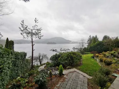a garden with a view of a body of water at Deep Cove Stunning Waterfront Whole House in North Vancouver