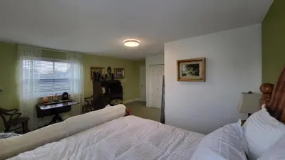 a bedroom with a bed and a desk in it at sweet home in Richmond