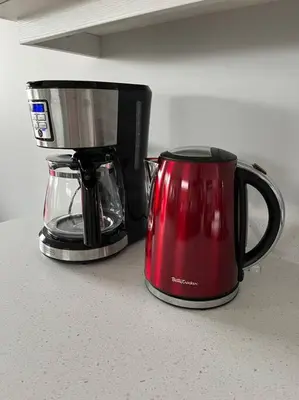 two coffee pots sitting next to each other on a counter at Ocean View Oasis in Campbell River