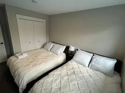 two beds sitting next to each other in a bedroom at Ocean View Oasis in Campbell River