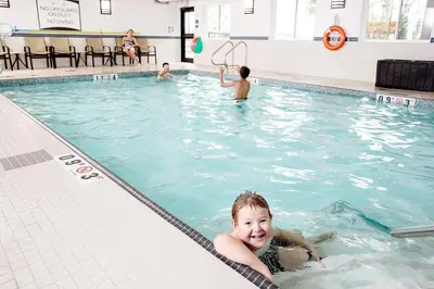 a young boy swimming in a swimming pool at Staybridge Suites West Edmonton by IHG in Edmonton
