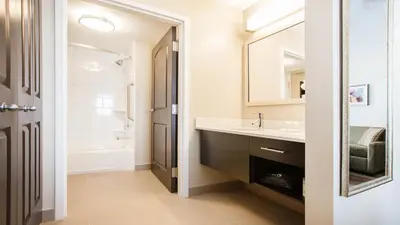 a bathroom with a sink and a mirror at Staybridge Suites West Edmonton by IHG in Edmonton