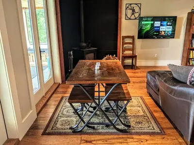 a living room with a wooden table and a couch at Mountain House of Wonder in Qualicum Beach