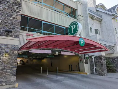 a building with a parking garage in front of it at King Edward Hotel in Banff