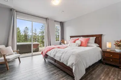 a bedroom with a bed and a large window at Heaven's Haven in Vernon