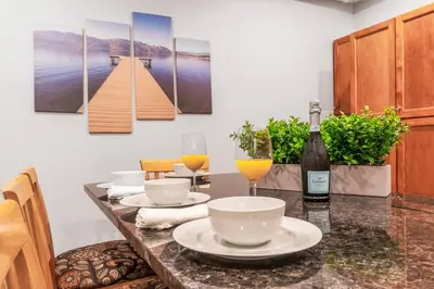 a dining table with a bottle of wine and a glass at Heaven's Haven in Vernon