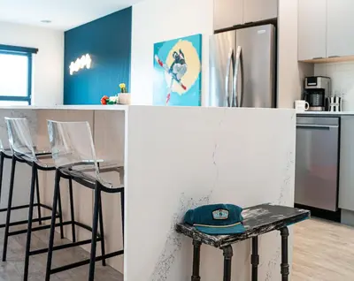 a kitchen with a counter with a hat on a stool at The Ski Shanty by Revelstoke Vacations in Revelstoke