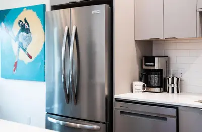 a stainless steel refrigerator in a kitchen at The Ski Shanty by Revelstoke Vacations in Revelstoke