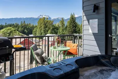 a balcony of a house with a table and chairs at The Ski Shanty by Revelstoke Vacations in Revelstoke