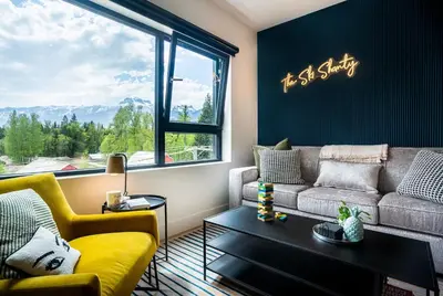 a living room with a couch and a table at The Ski Shanty by Revelstoke Vacations in Revelstoke
