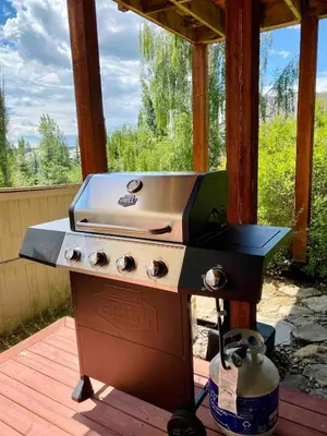 a grill sitting on a deck with a stove at Private, Spacious, & Bright Home in Calgary