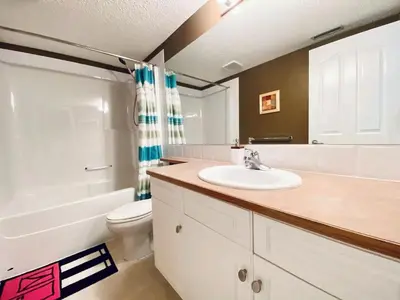 a bathroom with a sink and a toilet at Private, Spacious, & Bright Home in Calgary
