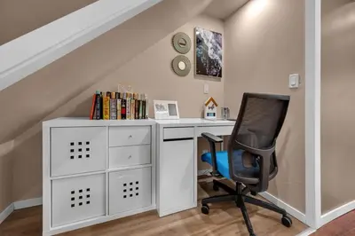 a room with a desk and a chair at 52-3 Bed Suite On Lake Central Ac By Airport in Calgary