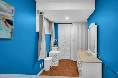 a blue and white bathroom with a sink and a toilet at 52-3 Bed Suite On Lake Central Ac By Airport in Calgary