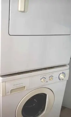 a white washer and dryer in a room at 52-3 Bed Suite On Lake Central Ac By Airport in Calgary