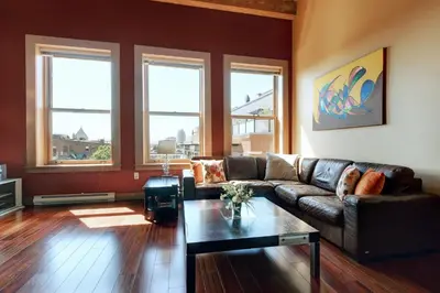 a living room with a couch and a table at Unique Style 2 Bedroom 2 Bath Condo In Old Town Victoria in Victoria