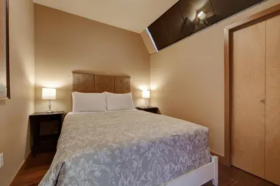 a small room with a bed and two lamps at Unique Style 2 Bedroom 2 Bath Condo In Old Town Victoria in Victoria