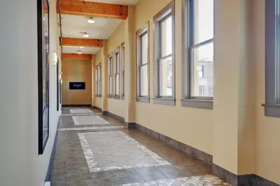 an empty hallway in a building with windows at Unique Style 2 Bedroom 2 Bath Condo In Old Town Victoria in Victoria