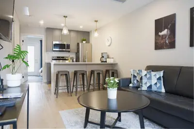 a living room with a couch and a table at Enchanted Mountain Getaway in Canmore