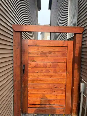 a wooden gate on the side of a house at Grande Villa in Calgary