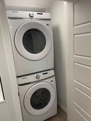 a washing machine and a washer in a kitchen at Grande Villa in Calgary