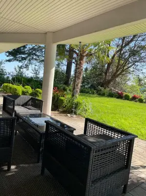 a patio with a table and chairs on a porch at Saanichton Waterfront 2BR suite with superb views in Saanichton