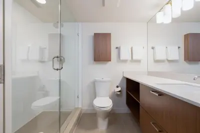 a bathroom with a toilet and a glass shower at Level Vancouver Yaletown Seymour in Vancouver