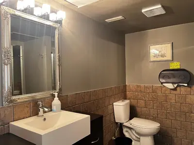 a bathroom with a white sink and a toilet at Grie hunting quite room! in Calgary