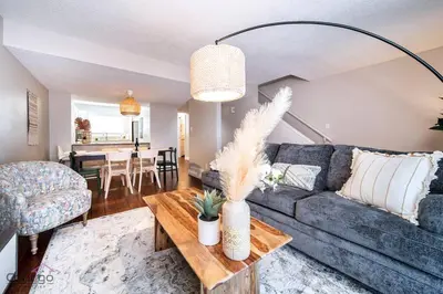a living room with a couch and a table at Cozy 3BD w/AC, Patio, Theatre Room, 15 min to DT in Edmonton