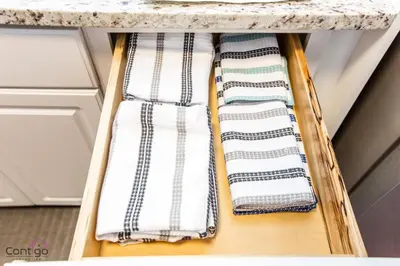 two towels on a shelf under a kitchen counter at Cozy 3BD w/AC, Patio, Theatre Room, 15 min to DT in Edmonton