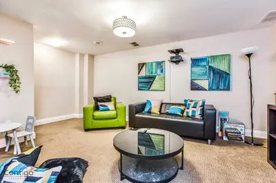 a living room with a couch and a table at Cozy 3BD w/AC, Patio, Theatre Room, 15 min to DT in Edmonton