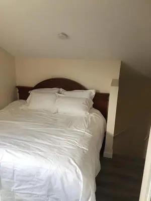 a white bed with white sheets and pillows at unit #302 Mountain view 2 beds in DT in Canmore