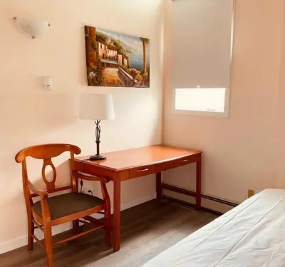 a desk with a lamp and a chair in a room at unit #302 Mountain view 2 beds in DT in Canmore