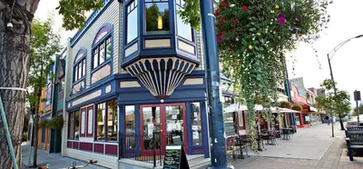 a blue and white building on a city street at Tranquil Retreat Spacious 2-Bedroom on the 2nd Floor in Kelowna