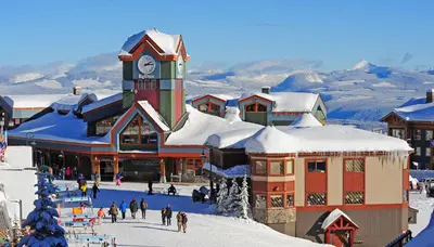 a large building with a clock tower in the snow at Tranquil Retreat Spacious 2-Bedroom on the 2nd Floor in Kelowna