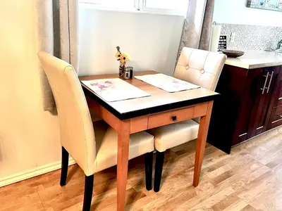 a dining room table with two chairs and a wooden table with a table at Kelowna little Island near Downtown, lake, hospital and Okanagan Collage in Kelowna