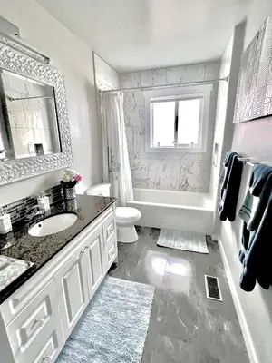 a bathroom with a sink and a toilet and a mirror at Kelowna little Island near Downtown, lake, hospital and Okanagan Collage in Kelowna