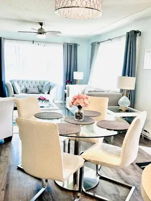 a living room with a dining table and chairs at Kelowna little Island near Downtown, lake, hospital and Okanagan Collage in Kelowna
