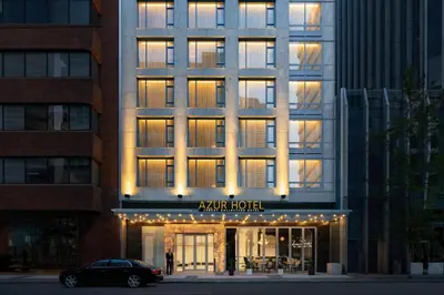 a hotel with a car parked in front of it at AZUR Legacy Collection Hotel in Vancouver