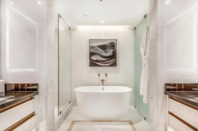 a bathroom with a white tub and a sink at AZUR Legacy Collection Hotel in Vancouver