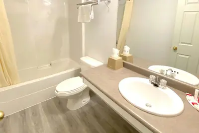 a white bathroom with a sink and a toilet at Super 8 by Wyndham Sicamous in Sicamous