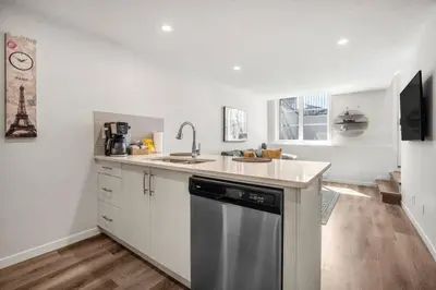 a kitchen with a sink and a dishwasher at Rockland Oasis: 1BR + Parking in Calgary