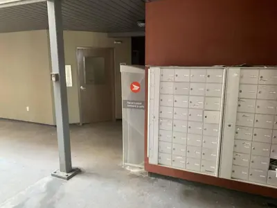 a group of lockers in a room with a door at Chris's Cozy Condo Times Square Rogers Place Edmonton in Edmonton