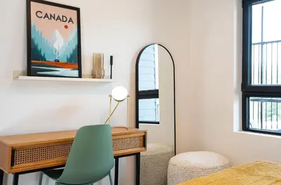 a room with a desk and a green chair at Prime Revy Penthouse in Revelstoke