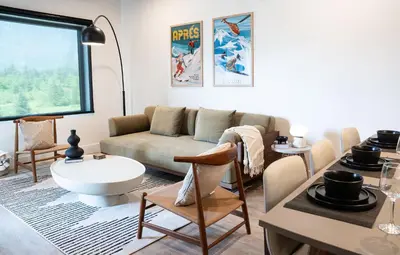 a living room with a couch and a table at Prime Revy Penthouse in Revelstoke