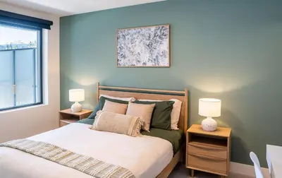 a bedroom with a bed with two night stands at Stoked On Revy - Family Condo in Revelstoke in Revelstoke